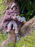 Savage Crucible's Jaeger, drapped in a cloak and holding a crossbow. He stands on a rotten, mossy tree trunk.